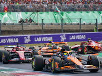 Oscar Piastri of Australia drives the (81) McLaren F1 Team MCL38 and Charles Leclerc of Monaco drives the (16) Scuderia Ferrari SF-24 during...