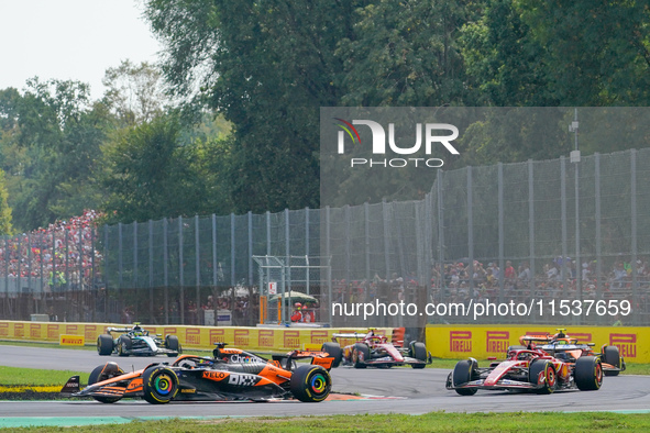 Oscar Piastri of Australia drives the (81) McLaren F1 Team MCL38 and Charles Leclerc of Monaco drives the (16) Scuderia Ferrari SF-24 during...