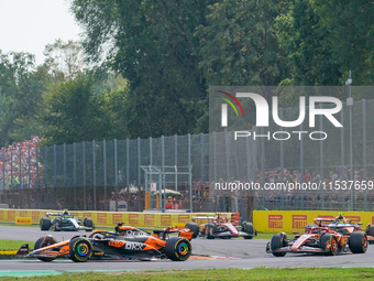 Oscar Piastri of Australia drives the (81) McLaren F1 Team MCL38 and Charles Leclerc of Monaco drives the (16) Scuderia Ferrari SF-24 during...