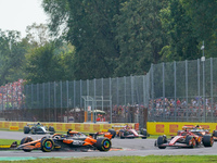 Oscar Piastri of Australia drives the (81) McLaren F1 Team MCL38 and Charles Leclerc of Monaco drives the (16) Scuderia Ferrari SF-24 during...