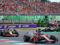 Charles Leclerc of Monaco drives the (16) Scuderia Ferrari SF-24 and Lando Norris of the United Kingdom drives the (04) McLaren F1 Team MCL3...