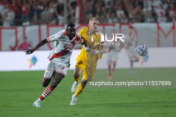 Davis Mensah of Mantova 1911 contrasts with Tijs Velthius of US Salernitana 1919 during the Italian Serie B soccer championship football mat...