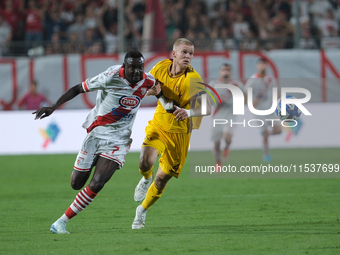 Davis Mensah of Mantova 1911 contrasts with Tijs Velthius of US Salernitana 1919 during the Italian Serie B soccer championship football mat...