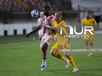 Davis Mensah of Mantova 1911 contrasts with Tijs Velthius of US Salernitana 1919 during the Italian Serie B soccer championship football mat...