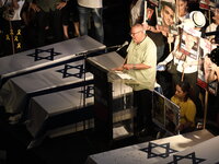 Israeli Labor Federation chief Arnon Bar-David speaks in front of dozens of thousands of Israelis who protest against the Israeli government...