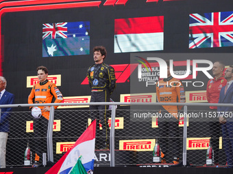 Charles Leclerc, Oscar Piastri, and Lando Norris stand on the podium during the Race of the Formula 1 Pirelli Gran Premio d'Italia 2024 in M...