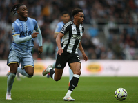 Newcastle United's Jacob Murphy breaks away from Tottenham Hotspur's Destiny Udogie during the Premier League match between Newcastle United...