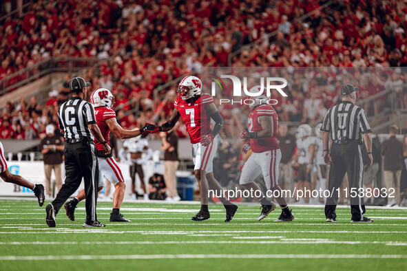 The Wisconsin Badgers defense celebrates a defensive stop against the Western Michigan Broncos at Camp Randall Stadium in Madison, Wisconsin...