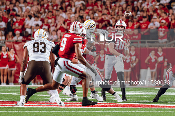 Wisconsin Badgers quarterback Tyler Van Dyke #10 threads a pass to Wisconsin Badgers wide receiver Bryson Green #9 at Camp Randall Stadium i...