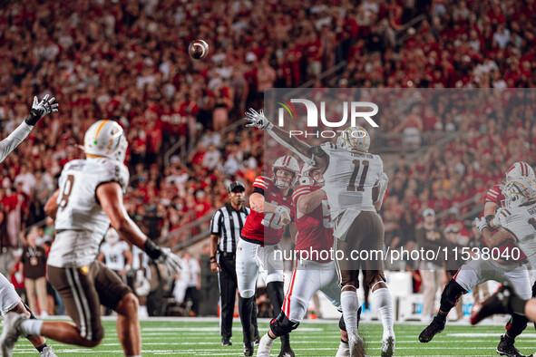 Wisconsin Badgers quarterback Tyler Van Dyke #10 throws a pass across the middle of the field against the Western Michigan Broncos at Camp R...