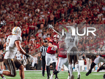 Wisconsin Badgers quarterback Tyler Van Dyke #10 throws a pass across the middle of the field against the Western Michigan Broncos at Camp R...