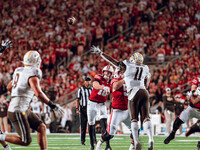 Wisconsin Badgers quarterback Tyler Van Dyke #10 throws a pass across the middle of the field against the Western Michigan Broncos at Camp R...