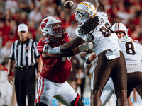 Wisconsin Badgers offensive lineman Jack Nelson #79 holds off Western Michigan defensive lineman Rodney McGraw #99 at Camp Randall Stadium i...