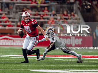 Wisconsin Badgers quarterback Tyler Van Dyke #10 avoids Western Michigan cornerback Nyquann Washington #13 at Camp Randall Stadium in Madiso...