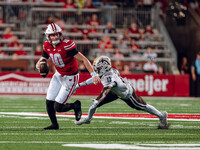 Wisconsin Badgers quarterback Tyler Van Dyke #10 avoids Western Michigan cornerback Nyquann Washington #13 at Camp Randall Stadium in Madiso...