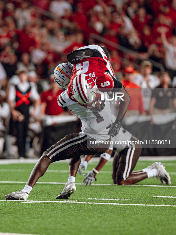 Wisconsin Badgers wide receiver Will Pauling #6 gets tackled by Western Michigan cornerback Bilhal Kone #1 at Camp Randall Stadium in Madiso...