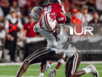 Wisconsin Badgers wide receiver Will Pauling #6 gets tackled by Western Michigan cornerback Bilhal Kone #1 at Camp Randall Stadium in Madiso...