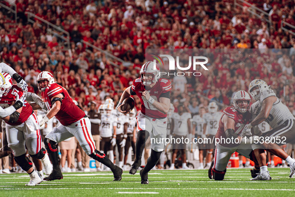 Wisconsin Badgers quarterback Tyler Van Dyke #10 runs for a touchdown against the Western Michigan Broncos at Camp Randall Stadium in Madiso...