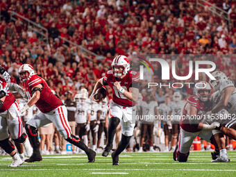 Wisconsin Badgers quarterback Tyler Van Dyke #10 runs for a touchdown against the Western Michigan Broncos at Camp Randall Stadium in Madiso...