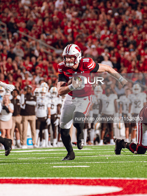 Wisconsin Badgers quarterback Tyler Van Dyke #10 runs for a touchdown against the Western Michigan Broncos at Camp Randall Stadium in Madiso...