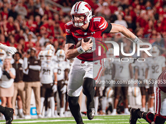 Wisconsin Badgers quarterback Tyler Van Dyke #10 runs for a touchdown against the Western Michigan Broncos at Camp Randall Stadium in Madiso...