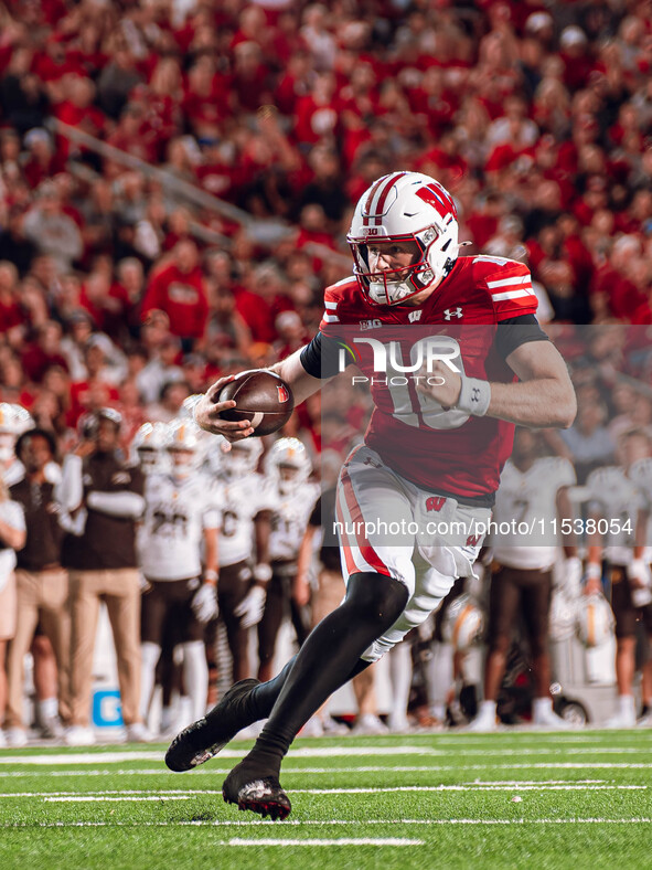 Wisconsin Badgers quarterback Tyler Van Dyke #10 runs for a touchdown against the Western Michigan Broncos at Camp Randall Stadium in Madiso...