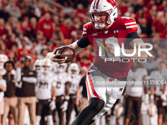 Wisconsin Badgers quarterback Tyler Van Dyke #10 runs for a touchdown against the Western Michigan Broncos at Camp Randall Stadium in Madiso...