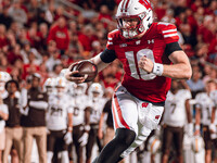 Wisconsin Badgers quarterback Tyler Van Dyke #10 runs for a touchdown against the Western Michigan Broncos at Camp Randall Stadium in Madiso...