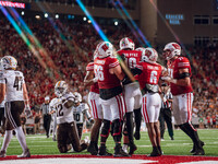 The Wisconsin Badger offense celebrates a touchdown run by Wisconsin Badgers quarterback Tyler Van Dyke #10 against the Western Michigan Bro...