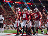 The Wisconsin Badger offense celebrates a touchdown run by Wisconsin Badgers quarterback Tyler Van Dyke #10 against the Western Michigan Bro...