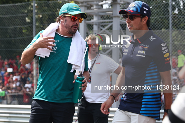 Fernando Alonso of Aston Martin Aramco and Sergio Perez of Red Bull Racing before the Formula 1 Italian Grand Prix at Autodromo Nazionale di...