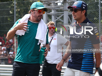 Fernando Alonso of Aston Martin Aramco and Sergio Perez of Red Bull Racing before the Formula 1 Italian Grand Prix at Autodromo Nazionale di...