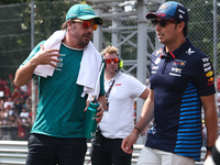 Fernando Alonso of Aston Martin Aramco and Sergio Perez of Red Bull Racing before the Formula 1 Italian Grand Prix at Autodromo Nazionale di...