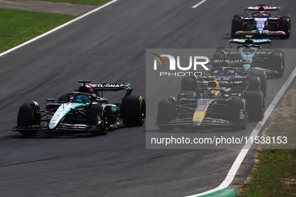 George Russell of Mercedes and Sergio Perez of Red Bull Racing during the Formula 1 Italian Grand Prix at Autodromo Nazionale di Monza in Mo...