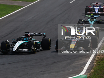 George Russell of Mercedes and Sergio Perez of Red Bull Racing during the Formula 1 Italian Grand Prix at Autodromo Nazionale di Monza in Mo...