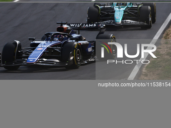 Alexander Albon of Williams, Fernando Alonso of Aston Martin Aramco and Daniel Ricciardo of RB during the Formula 1 Italian Grand Prix at Au...