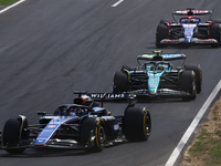 Alexander Albon of Williams, Fernando Alonso of Aston Martin Aramco and Daniel Ricciardo of RB during the Formula 1 Italian Grand Prix at Au...