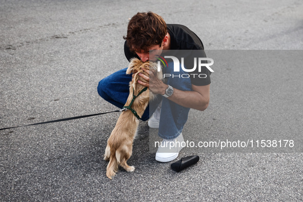 Charles Leclerc of Ferrari is seen with his puppy Leo, a miniature longhaired dachshund, after winning the Italian Formula One Grand Prix at...