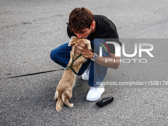 Charles Leclerc of Ferrari is seen with his puppy Leo, a miniature longhaired dachshund, after winning the Italian Formula One Grand Prix at...