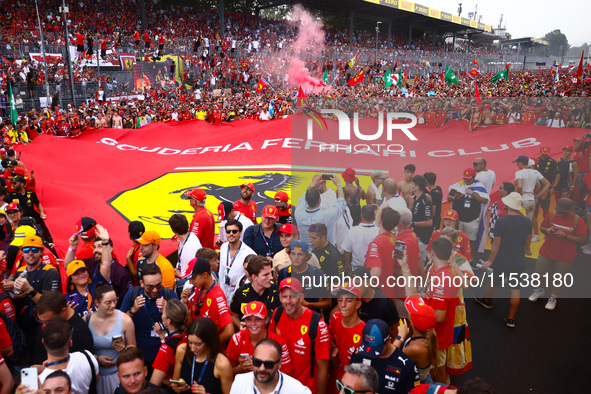 Tifosi celebrate after Charles Leclerc of Ferrari wins the Italian Formula One Grand Prix at Autodromo Nazionale Monza circuit, in Monza on...