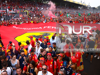 Tifosi celebrate after Charles Leclerc of Ferrari wins the Italian Formula One Grand Prix at Autodromo Nazionale Monza circuit, in Monza on...