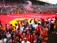 Tifosi celebrate after Charles Leclerc of Ferrari wins the Italian Formula One Grand Prix at Autodromo Nazionale Monza circuit, in Monza on...