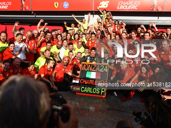 Charles Leclerc and Carlos Sainz of Ferrari celebrate with thier team after Leclerc won the Italian Formula One Grand Prix at Autodromo Nazi...