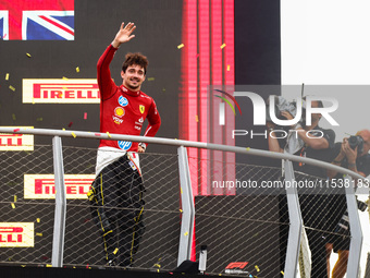 Charles Leclerc of Ferrari celebrates on the podium after winning the Italian Formula One Grand Prix at Autodromo Nazionale Monza circuit, i...