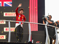 Charles Leclerc of Ferrari celebrates on the podium after winning the Italian Formula One Grand Prix at Autodromo Nazionale Monza circuit, i...