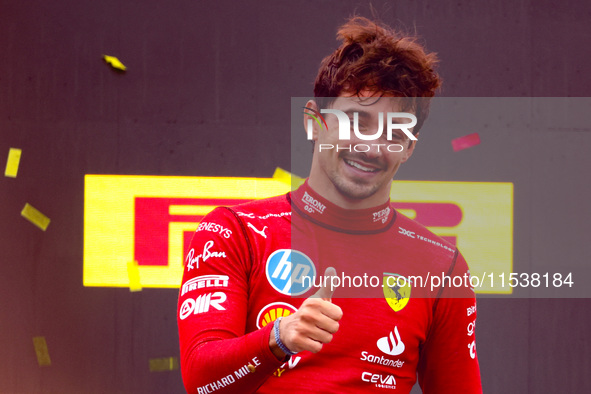 Charles Leclerc of Ferrari celebrates on the podium after winning the Italian Formula One Grand Prix at Autodromo Nazionale Monza circuit, i...