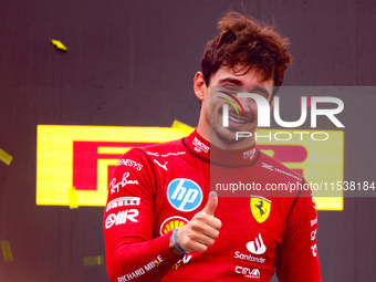 Charles Leclerc of Ferrari celebrates on the podium after winning the Italian Formula One Grand Prix at Autodromo Nazionale Monza circuit, i...