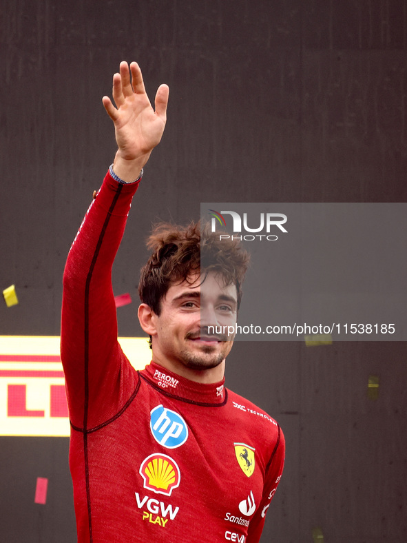 Charles Leclerc of Ferrari celebrates on the podium after winning the Italian Formula One Grand Prix at Autodromo Nazionale Monza circuit, i...