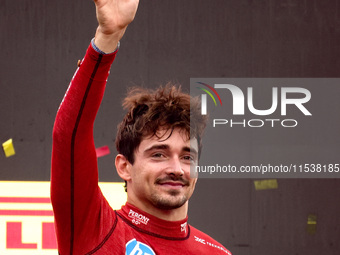 Charles Leclerc of Ferrari celebrates on the podium after winning the Italian Formula One Grand Prix at Autodromo Nazionale Monza circuit, i...