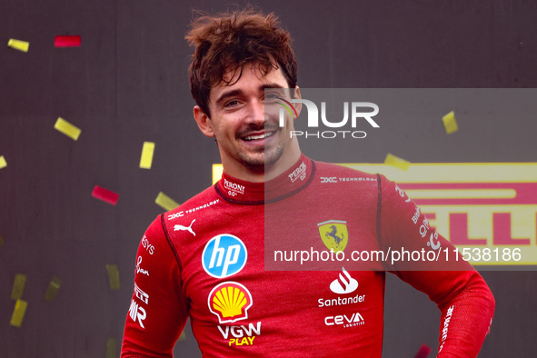 Charles Leclerc of Ferrari celebrates on the podium after winning the Italian Formula One Grand Prix at Autodromo Nazionale Monza circuit, i...